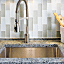 Pieces of glass are embedded in a Vetrazzo countertop.