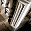 Carpeting against hardwood down the main stairwell to the...