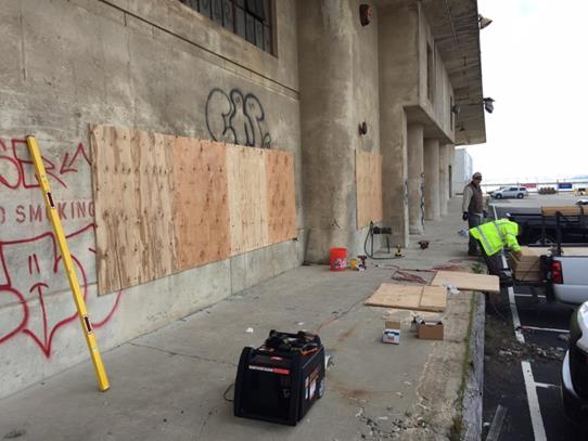 Facilities staff boarding up Port buildings
