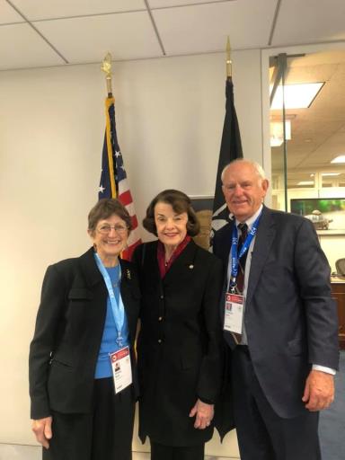 Image may contain: 3 people, including Tom Butt, people smiling, people standing and suit