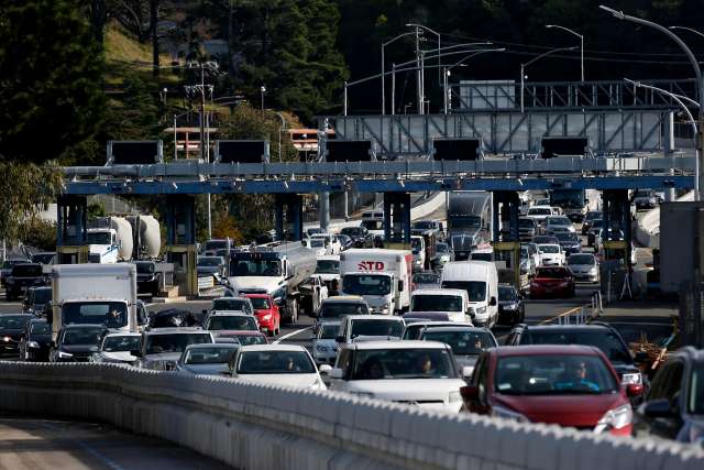 Traffic funnels into two westbound lanes after passing through the toll plaza on the bridge.