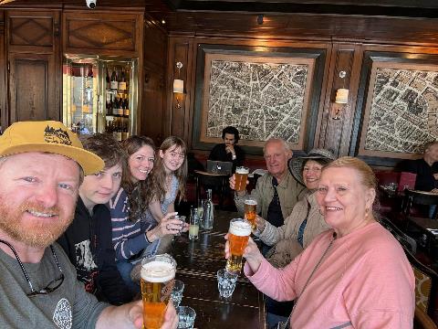 A group of people sitting at a table with drinks Description automatically generated