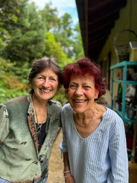 Two women smiling at the camera Description automatically generated